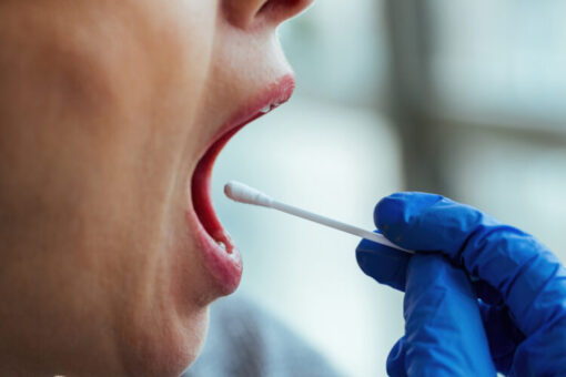 Close-up of mouth swab drug test being performed for rapid at-home substance screening