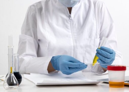 Laboratory technician processing a DOT pre-employment urine drug test sample at a laboratory facility