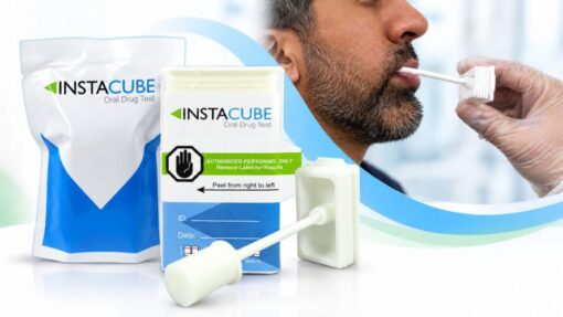 Person swabbing inside mouth using an InstaCube saliva drug test device