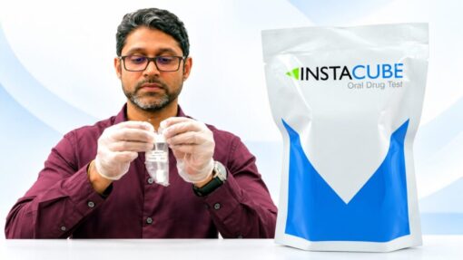 Lab technician opening an InstaCube saliva THC drug test kit for workplace screening